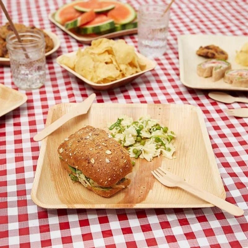 Eco-friendly palm leaf plates and cutlery, perfect for sustainable outdoor dining and picnics.