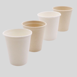 Set of four eco-friendly bamboo pulp cups in varying shades of natural beige and white, suitable for hot beverages.