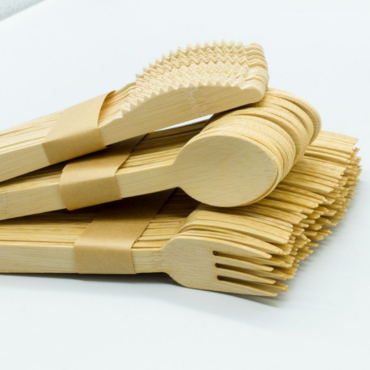 Bulk biodegradable bamboo cutlery set, including forks, knives, and spoons, bundled with eco-friendly paper bands.