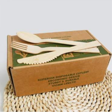 Biodegradable bamboo cutlery set with eco-friendly packaging, including a fork, knife, spoon, and stirrer.